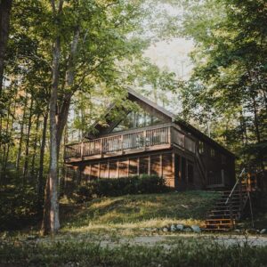 brown wooden house surrounded by green trees during daytime